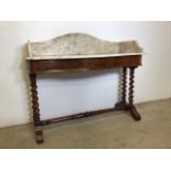 A serpentine front mahogany marble topped wash stand with large barley twist legs and turned