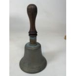 A brass handle bell with wooden handle with working clapper W:14cm x H:27cm