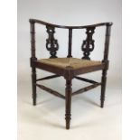 A 19th century rattan seated corner chair with curved back and lyre supports. W:61cm x D:61cm x H: