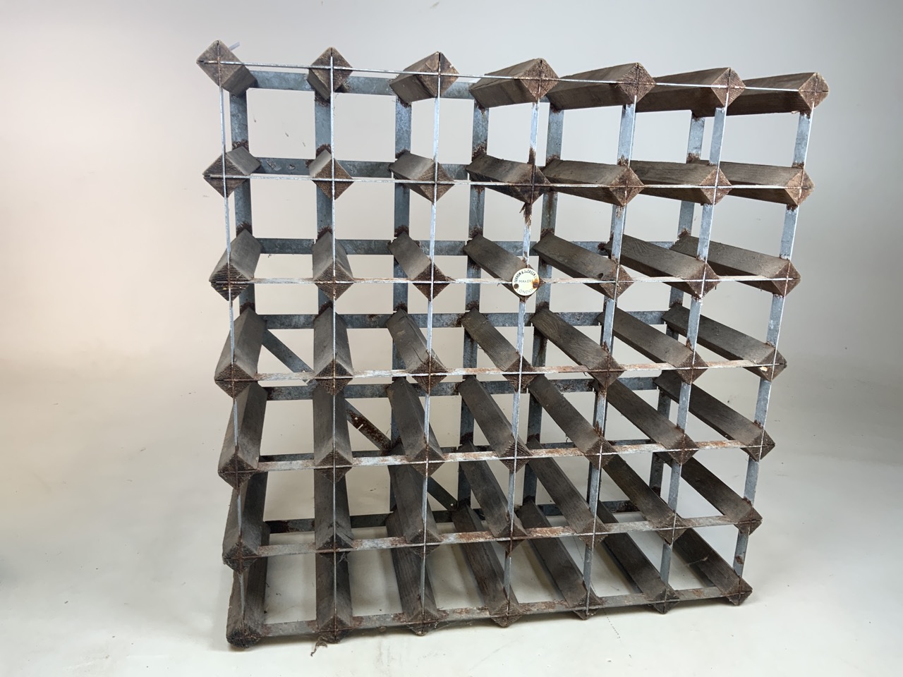 A vintage Farrow & Jackson vintage wine rack for thirty six bottles. Manufacturers label to front