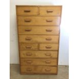 A mid century oak fronted ten drawer tall boy with original handles. W:91cm x D:41cm x H:158cm