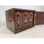 A mahogany chest with six lettered drawers, brass campaign handles to the side. With large