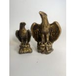 A pair of gilt painted resin golden eagles. H:29cm and H:24cm