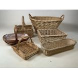 A collection of baskets including a childs shopping basket and a laundry basket