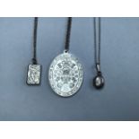 A collection of sterling silver items, a royal commemorative pendant, a book locket and a small oval