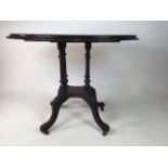 An early 20th century oak oval tilt top table. W:90cm x D:57cm x H:66cm