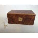 A birds eye maple humidor by Dunhill with two keys. W:28cm x D:16cm x H:13cm
