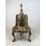 A Victorian brass and metal room heater with lion paw feet and decorative swan handle. W:38cm x D: