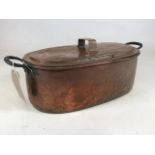 A Victorian copper twin handled fish kettle and cover, 63cm wide