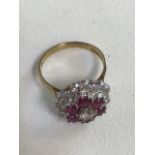 A London hall marked 750, 18ct Diamond and ruby cluster ring.
