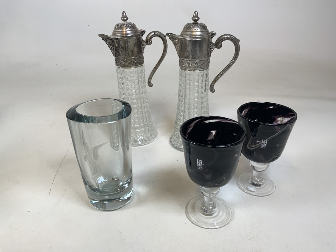 A pair of Italian glass and white metal topped claret jugs together with a pair of Medina glass