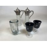 A pair of Italian glass and white metal topped claret jugs together with a pair of Medina glass