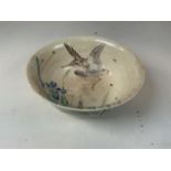 An oriental hand painted bowl with bird image to interior. Oriental markings to base. Chip to rim