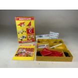 A Meccano C building kit. Three boxes, screws and instruction manuel.