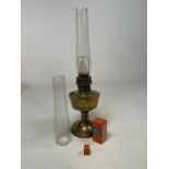 An Aladdin brass oil lamp with accessories and extra glass.