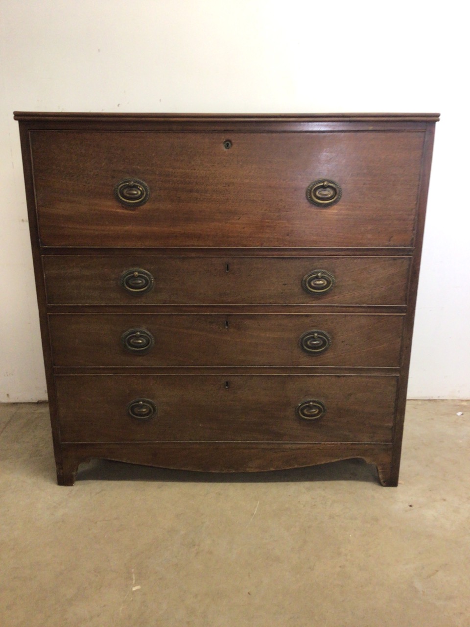 A Victorian mahogany secretaire chest with brass handles. With drop down drawer to interior inlaid