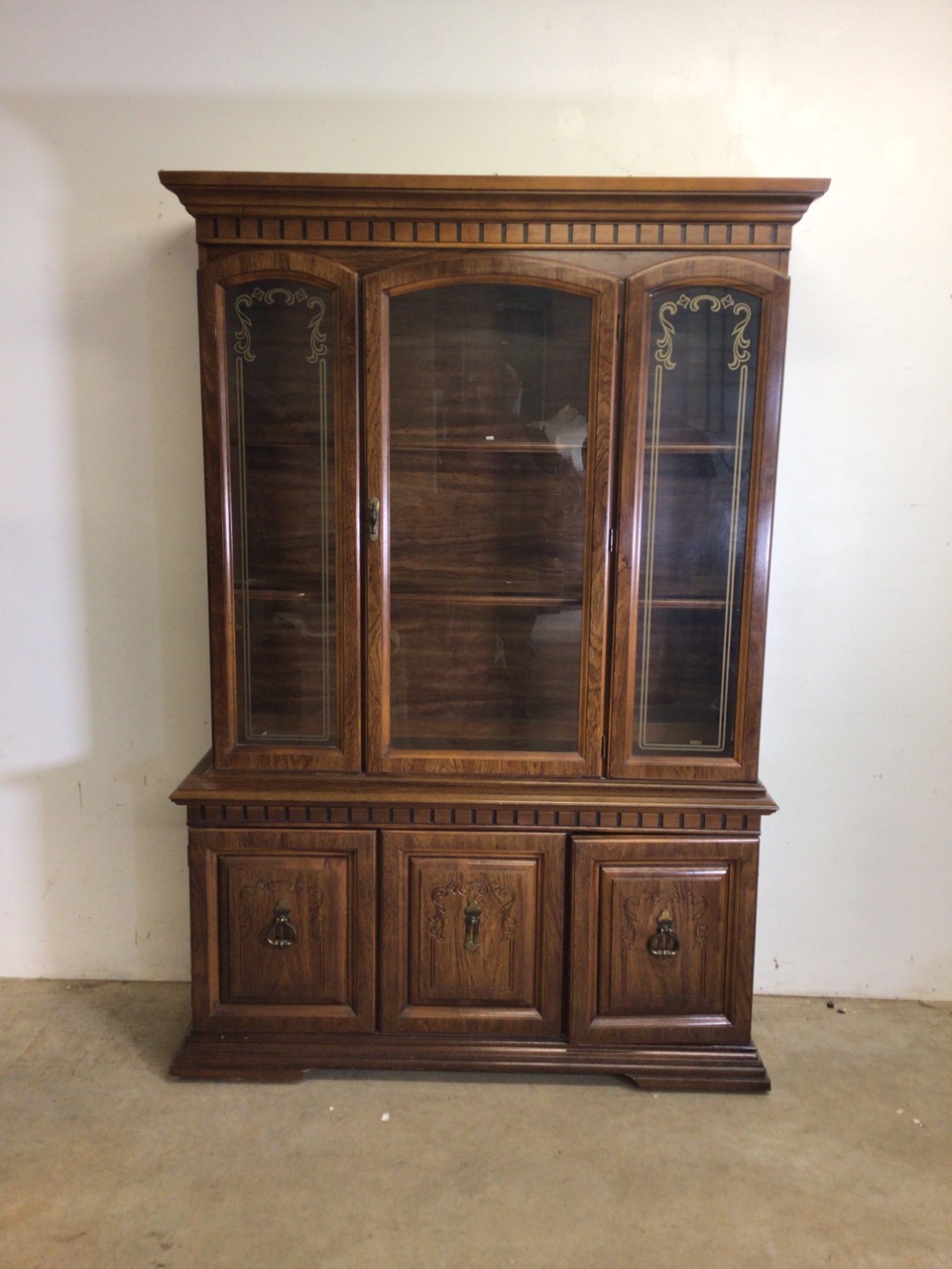 A reproduction glazed two piece display cupboard with decorated glass and cupboard beneath. W: