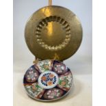 An Imari style Japanese charger (restored) 42cm together with an Eastern brass charger engraved with