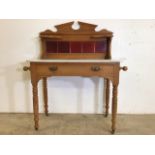 A pine marble topped washstand with tiled back, large central drawer with brass handles on turned