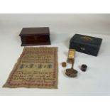 Sewing interest. A sampler dated 1828 together with a wooden spindle, tape measure, silver