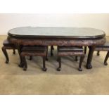 An oriental hardwood coffee table with heavily carved top under glass, with nest of six occasion