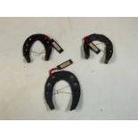 Three antique horse shoes