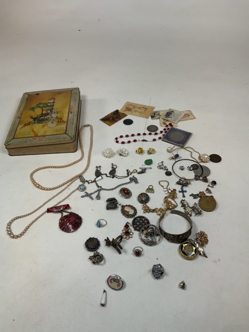 A sharps toffee Tin with a collection of costume jewellery