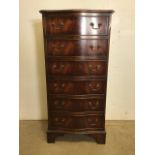 A mahogany serpentine fronted bank of six drawers with brass handles. W:51cm x D:40cm x H:105cm