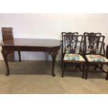 A mahogany extending table on cabriole legs with two extra leaves with four Victorian chairs to