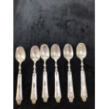 A set of Six decorative white metal dessert spoons marked 800, Gross. 9.40 oz
