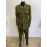 A military Craftsman suit in green serge with Royal Electrical and Mechanical Engineers insignia.