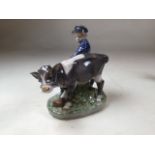 A ROYAL COPENHAGEN PORCELAIN BOY & CALF GROUP, printed and painted factory marks to base, includes