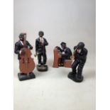 A vintage ceramic jazz band comprising four figures. Tallest figure 24cm