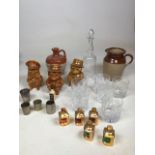 A decanter together with tumblers, drinks measures, miniatures, Torquay Pottery character jugs and