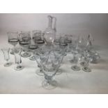A collection of glassware including silver colour trimmed glasses, glass jugs and other glasses