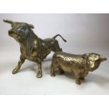 Two large brass bulls W:52cm x H:26cm largest bull