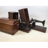 Three cased vintage sewing machines including two Singers and another.