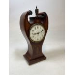 Veneered mantel clock with distinctive twin scroll pediment with brass finial to centre. Decorated