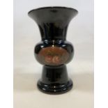 A black ceramic vase with floral decoration.W:21cm x D:21cm x H:32cm