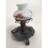 A small metal candle stand with opaque glass shade with hand painted flower.H:22cm