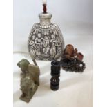 A 20th century pottery lamp together with soapstone and wooden collectibles including lion book ends