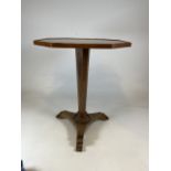 An octagonal table on walnut veneered tapered base with carved leaf details. W:60cm x D:60cm x H: