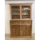 A large pitch pine Victorian two part glazed cupboard.W:159cm x D:56cm x H:239cm