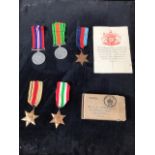 A collection of World War 2 medals in original postage box. The defence medal, the war medal, the