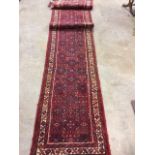 A five meter long Iranian wool runner. W:507cm x D:83cm x