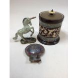 A brass lidded decorative ceramic jar also with a metal unicorn and a boys brigade badge. Jar H: