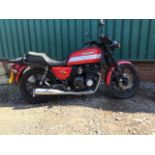 A 1991 Kawasaki GT550 registration number J792 LLR, red. This large sports bike has been in dry