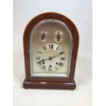 A mahogany arched case mantle clock with silvered dial. With pendulum, no key. Untested W:25cm x