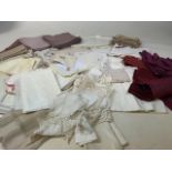 A large collection of table linen to include napkins, dollies and embroidered tray cloths