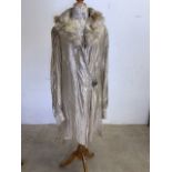 A 1920s metallic coat with fur collar and ruched sleeves